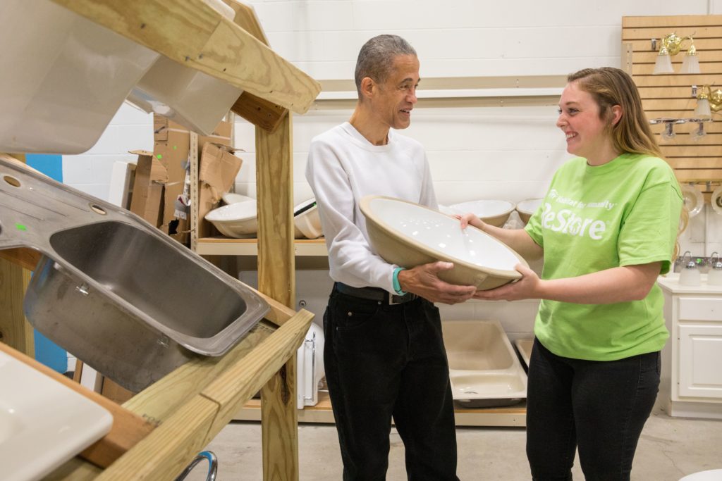 ReStore employee showing customer a sink in the plumbing section